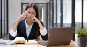 Portrait of an unhappy female boss or businesswoman unsatisfied with the business deal from her partner on the phone call. Businesswoman with a serious phone call.